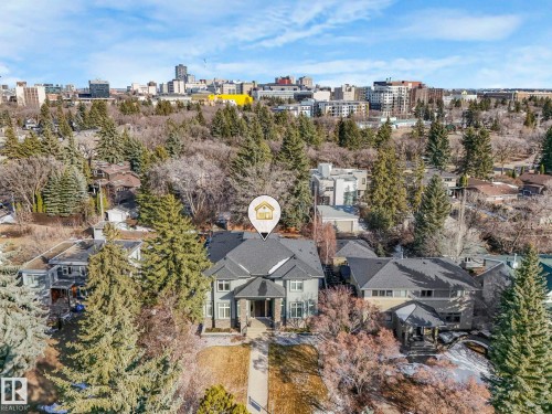 Expansive residential property with a multi-gabled roofline and a distinguished stone facade - 8927 120 Street, Edmonton, AB - Outdoor With View