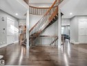 Curved staircase with wood-finish treads and wrought iron spindles - 8927 120 Street, Edmonton, AB  - Indoor Photo Showing Other Room 