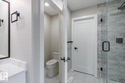 Bathroom with a glass-enclosed shower featuring wood-finish tile - 