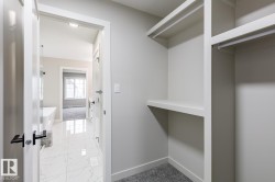 Walk-in closet with built-in shelving and hanging rods - 