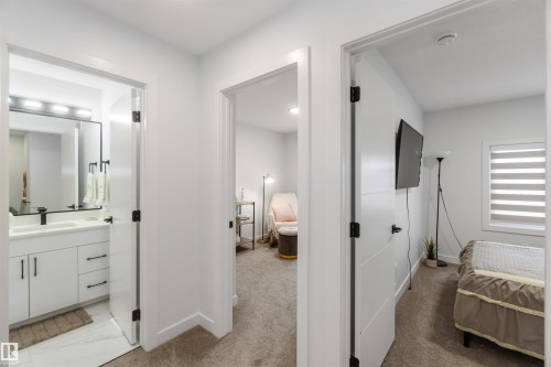 Corridor featuring white painted walls and contrasting dark hardware - 124 28 Street, Edmonton, AB 