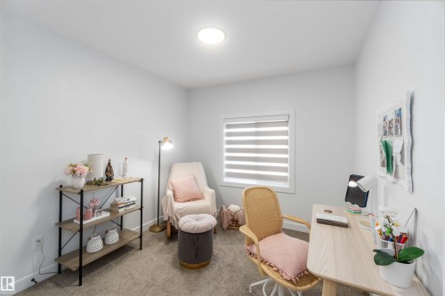 Carpeted room with a rectangular window featuring horizontal blinds - 124 28 Street, Edmonton, AB 