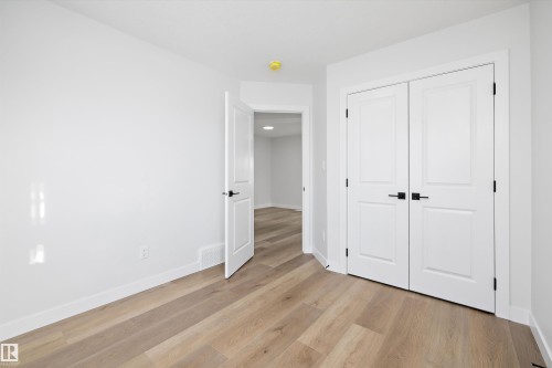 Room featuring light wood-finish flooring, white walls, and white baseboards - 954 Elderberry Landing, Edmonton, AB - Indoor Photo Showing Other Room