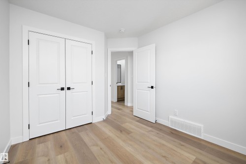 Interior room featuring light wood-finish flooring and white baseboards - 954 Elderberry Landing, Edmonton, AB - Indoor Photo Showing Other Room