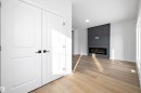 White paneled double doors with matte black hardware - 954 Elderberry Landing, Edmonton, AB  - Indoor With Fireplace 