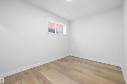 Room featuring light wood-finish flooring, white walls, and a recessed ceiling light - 