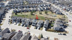 Suburban property featuring an asphalt shingle roof, attached garage, and a fenced backyard backing onto a green space - 