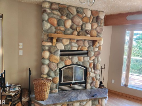 404, 59201 Range Road 95, Rural St. Paul County, AB - Indoor Photo Showing Living Room With Fireplace