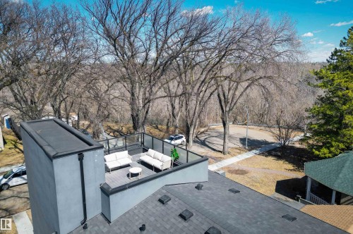 Rooftop deck featuring a glass railing system and durable composite flooring - 9741 90 Avenue, Edmonton, AB - Outdoor