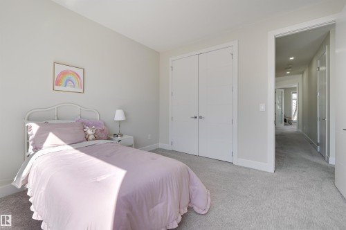 Bedroom featuring light gray wall paint, neutral carpet, and white trim - 9741 90 Avenue, Edmonton, AB - Indoor Photo Showing Bedroom