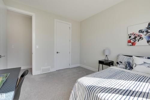 Neutral color palette with light gray walls, plush gray carpet flooring, and white trim - 9741 90 Avenue, Edmonton, AB - Indoor Photo Showing Bedroom