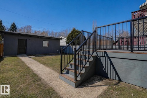 Exterior deck with dark gray composite decking and black metal railings - 9741 90 Avenue, Edmonton, AB - Outdoor