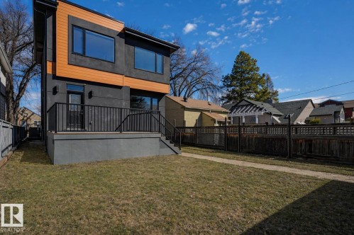 Contemporary exterior featuring dark-toned siding and horizontal wood-finish accents - 9741 90 Avenue, Edmonton, AB - Outdoor