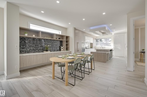 Open-concept interior featuring light wood-finish flooring throughout - 9741 90 Avenue, Edmonton, AB - Indoor Photo Showing Dining Room