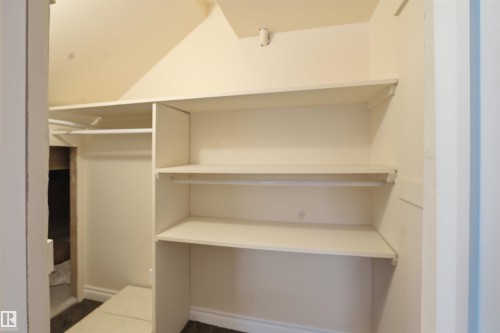 The property features a built-in closet with shelving and hanging rods - 6009 36 Avenue, Beaumont, AB - Indoor With Storage