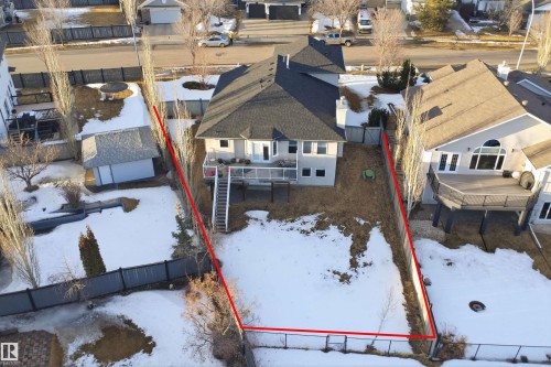 Spacious property featuring a large backyard, multi-level deck, rear access to lower patio, and a privacy fence - 6009 36 Avenue, Beaumont, AB - Outdoor