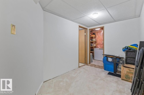 Recessed ceiling lighting illuminates a room featuring a drop ceiling and light-toned carpet flooring - 219 Knottwood Road N, Edmonton, AB - Indoor Photo Showing Other Room