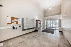 The property features a spacious lobby with tiled flooring, a high ceiling, and an array of mailboxes for convenience - 