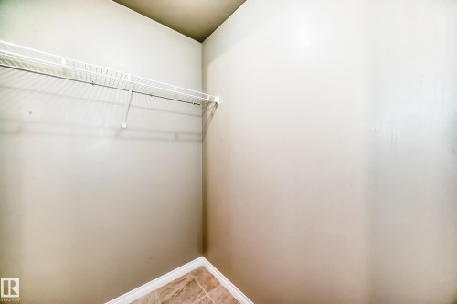 This area features a wire shelf and tiled flooring - 411 6925 199 Street Nw, Edmonton, AB - Indoor