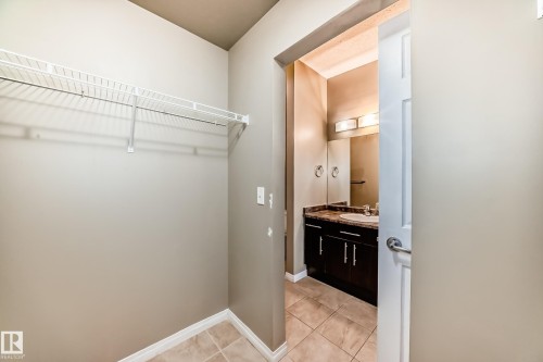 Storage area featuring a wire rack and tiled flooring - 411 6925 199 Street Nw, Edmonton, AB - Indoor Photo Showing Other Room