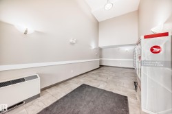 Spacious entryway featuring a high vaulted ceiling, light-toned walls, and tiled flooring - 