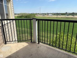 Private balcony with a concrete floor and black metal railings - 
