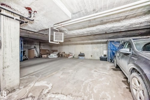 Underground parking space with concrete walls and ceiling - 411 6925 199 Street Nw, Edmonton, AB - Indoor Photo Showing Garage