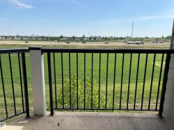 Balcony featuring concrete flooring and black metal railings - 