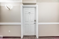 Entry door with panel details and silver-toned hardware - 