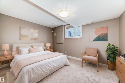 This bedroom features neutral-toned walls, a recessed window, and light-colored carpeting - 1605 Haswell Court, Edmonton, AB - Indoor Photo Showing Bedroom