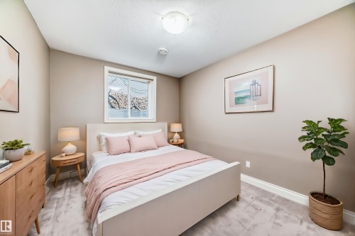This bedroom features neutral-toned walls, a window with a white frame, and light-colored flooring - 1605 Haswell Court, Edmonton, AB - Indoor Photo Showing Bedroom