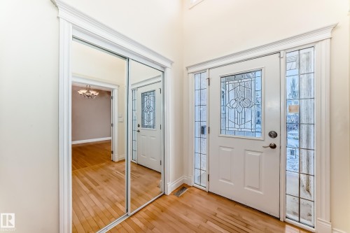 Foyer entrance with light wood-style flooring and suspended lighting - 1605 Haswell Court, Edmonton, AB - Indoor Photo Showing Other Room
