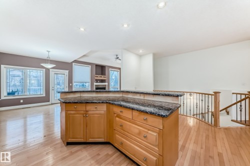 Kitchen with light wood-style floors, dark stone countertops, and plenty of natural light - 1605 Haswell Court, Edmonton, AB - Indoor Photo Showing Kitchen