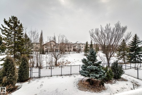 Snowy yard with a gate and a residential view - 1605 Haswell Court, Edmonton, AB - Outdoor