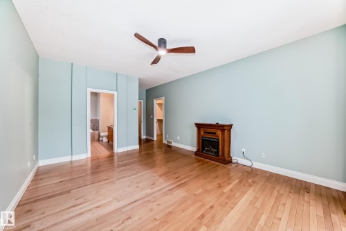 Unfurnished living room with light wood-style flooring, a fireplace, and ceiling fan - 1605 Haswell Court, Edmonton, AB - Indoor