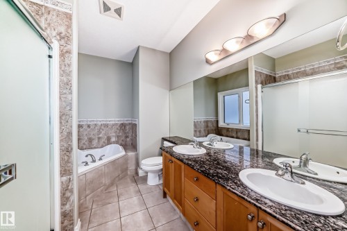 Full bath featuring a garden tub, double vanity, light tile patterned floors, and a stall shower - 1605 Haswell Court, Edmonton, AB - Indoor Photo Showing Bathroom