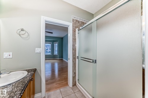 Bathroom with a shower stall, vanity, and light tile patterned flooring - 1605 Haswell Court, Edmonton, AB - Indoor Photo Showing Bathroom