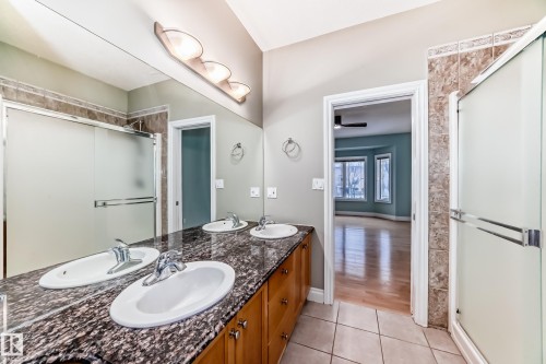 Bathroom with a stall shower, double vanity, and light tile patterned flooring - 1605 Haswell Court, Edmonton, AB - Indoor Photo Showing Bathroom