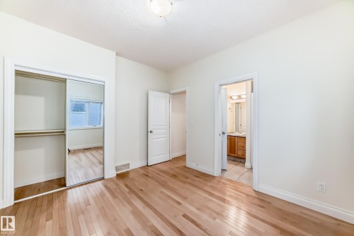 Unfurnished bedroom with light wood finished floors, a closet, and connected bathroom - 1605 Haswell Court, Edmonton, AB - Indoor Photo Showing Other Room