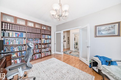 Office area with a chandelier, light wood-style flooring, and french doors - 1605 Haswell Court, Edmonton, AB - Indoor