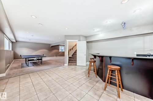 Indoor bar featuring recessed lighting, light colored carpet, and light tile patterned floors - 1605 Haswell Court, Edmonton, AB - Indoor Photo Showing Other Room