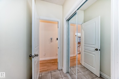 Hall with light tile patterned floors and baseboards - 1605 Haswell Court, Edmonton, AB - Indoor Photo Showing Other Room