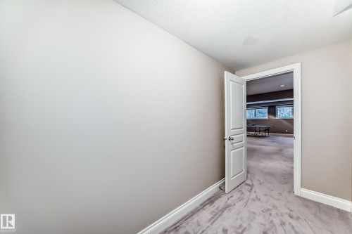Hall with baseboards and light colored carpet - 1605 Haswell Court, Edmonton, AB - Indoor Photo Showing Other Room