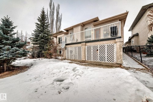 Snow covered property featuring a deck and stucco siding - 1605 Haswell Court, Edmonton, AB - Outdoor