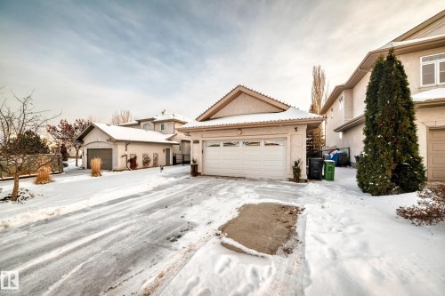 View of front of home with stucco siding, a garage, an outbuilding, and a tile roof - 1605 Haswell Court, Edmonton, AB - Outdoor