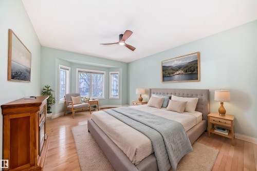 This room features hardwood floors, a large bay window, and a ceiling fan - 1605 Haswell Court, Edmonton, AB - Indoor Photo Showing Bedroom