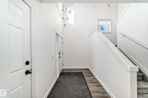 Entryway featuring baseboards and wood finished floors - 4008 37 Avenue, Edmonton, AB - Indoor Photo Showing Other Room