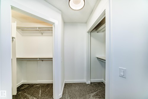 Walk in closet featuring dark colored carpet - 4008 37 Avenue, Edmonton, AB - Indoor