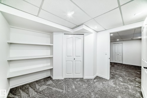 Finished below grade area with a drop ceiling, dark colored carpet, and recessed lighting - 4008 37 Avenue, Edmonton, AB - Indoor Photo Showing Other Room