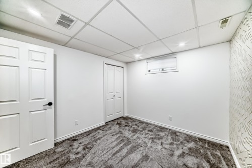 Finished below grade area with dark colored carpet, a paneled ceiling, and recessed lighting - 4008 37 Avenue, Edmonton, AB - Indoor Photo Showing Other Room